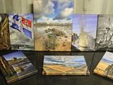 de nombreux tableaux posés sur une table noire, sur lesquels figurent des images