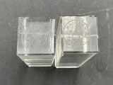 two clear glass cubes sitting on a table