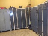 many blue lockers lined up in a row in a room
