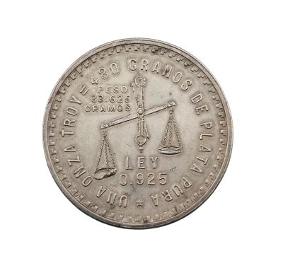 une image représentant une pièce d'argent sur laquelle figure une balance