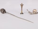 a silver spoon with a spoon rest and a spoon with a spoon in it
