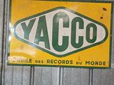 a yellow and green sign that says yacco on it
