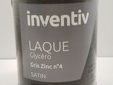 a can of paint sitting on a white surface
