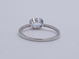 a close up of a ring with a blue topaz stone on it