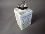 a small white box with a metal object on it