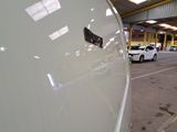 a white car parked in a parking lot next to a building