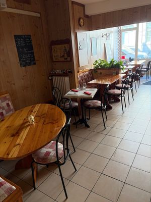 many tables and chairs in this restaurant with a lot of windows
