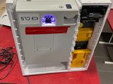 a small refrigerator that has a purple light on top of it