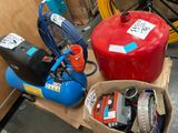 two air compressors and a box of tools on a table