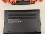 an orange case sitting on top of a white table next to a laptop
