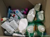 a cardboard box filled with plastic bottles and other items