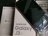 a black samsung phone sitting on top of a box