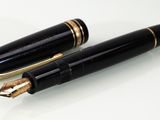 two pens sitting next to each other on a white surface
