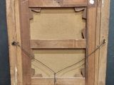 an old wooden picture frame with a picture hanging on the wall