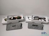 two pairs of glasses are sitting in a box on a table