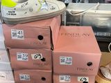 boxes of shoes are stacked on top of each other on a shelf
