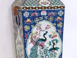 a blue vase with a peacock on it sitting on a table