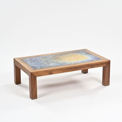 a small wooden table with a blue and yellow design on it