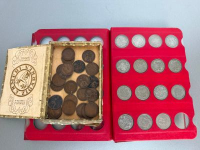 a red box with coins inside of it on a table