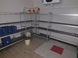 a picture of a room with a lot of shelves and a trash can