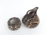 two vases sitting next to each other on a white surface