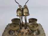 silver plated serving set with spoons and cups on a tray