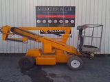 a picture of a yellow lift truck parked in front of a building