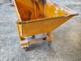a yellow dumpster sitting in the middle of a room