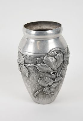 a silver vase with flowers on it on a white background