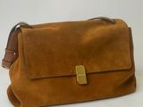 a brown sued bag with a gold buckle on the front