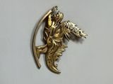 a gold fish and a bird brooch on a white surface