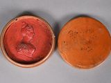 an image of a red and brown box with a bust of a woman