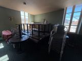 tables and chairs in a room with a view of a balcony