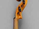an old violin with a long neck and a wooden stick