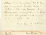 un vieux document sur lequel figure une lettre manuscrite, posé sur une table