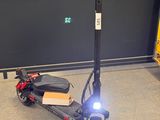 a scooter that is sitting on the floor in the garage