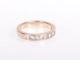 a close up of a diamond ring on a white surface