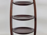 a wooden shelf with three plates on top of it