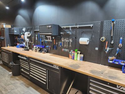a workbench with many tools on it in a garage