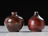 two vases that are sitting on a table