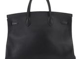 a black leather tote bag on a white background