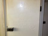 a white refrigerator sitting in a room with a tiled floor