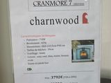 a sign on the table advertising the sale of a wood burning stove