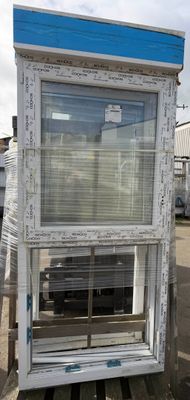 a white window with a blue top on a pallet