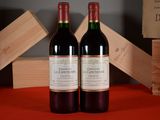 two bottles of wine sitting next to each other on a table