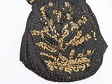 a black purse with a gold design on it