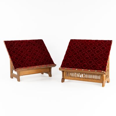 une paire de fauteuils rembourrés rouges avec des coussins en velours rouge