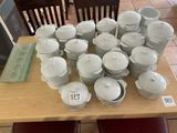 a table with a lot of dishes and cups on it