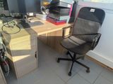 a desk with a chair and a computer on it