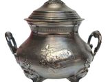 a large metal pot with a bird on top